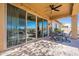 Covered patio with ceiling fan and dining set overlooking a serene golf course at 42225 N Celebration Way, Phoenix, AZ 85086