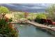 Relaxing pool area with lush landscaping and scenic views of the golf course at 42225 N Celebration Way, Phoenix, AZ 85086