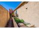 A view of the side yard with planter bed and flowering bougainvillea at 42225 N Celebration Way, Phoenix, AZ 85086