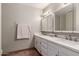 Clean bathroom with dual sinks, white cabinets, and updated fixtures at 518 E Colgate Dr, Tempe, AZ 85283