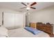 Bedroom with a queen bed, ceiling fan, and dresser, offering ample storage at 518 E Colgate Dr, Tempe, AZ 85283