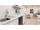 Modern kitchen with white cabinets, a farmhouse sink, and a wooden shelf at 5525 E Thomas Rd # M15, Phoenix, AZ 85018