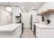 Modern kitchen boasts white cabinets, quartz countertops, and a breakfast bar at 5525 E Thomas Rd # M15, Phoenix, AZ 85018