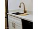 Modern kitchen sink with quartz countertop and gold faucet at 5525 E Thomas Rd # M15, Phoenix, AZ 85018