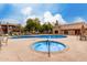 Community pool and spa with surrounding patio furniture at 5525 E Thomas Rd # M15, Phoenix, AZ 85018