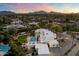 Stunning aerial view of the property at dusk with mountains in the background at 6039 E Laurel Ln, Scottsdale, AZ 85254