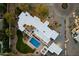 Aerial view of the property, showing a modern home with a pool, landscaped yard, and surrounding neighborhood at 6039 E Laurel Ln, Scottsdale, AZ 85254