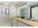 Bright bathroom featuring a double vanity with stone countertops and a glass-enclosed shower at 6039 E Laurel Ln, Scottsdale, AZ 85254