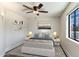 Comfortable bedroom with a ceiling fan, neutral colors, and a window overlooking the outdoors at 6039 E Laurel Ln, Scottsdale, AZ 85254