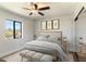 Bedroom with great natural light, carpet floors, and a ceiling fan with an exterior view at 6039 E Laurel Ln, Scottsdale, AZ 85254