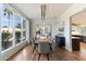 Bright dining room features hardwood floors, modern lighting, and a large window with neighborhood views at 6039 E Laurel Ln, Scottsdale, AZ 85254