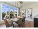 Bright dining room with modern lighting, large windows, and stylish furnishings at 6039 E Laurel Ln, Scottsdale, AZ 85254