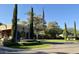 View of the entrance to the property with manicured landscaping and an American flag at 6039 E Laurel Ln, Scottsdale, AZ 85254