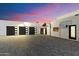 Modern home featuring a paved driveway leading to a three-car garage and basketball hoop at 6039 E Laurel Ln, Scottsdale, AZ 85254