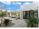 Modern home exterior featuring an open-air pergola, a pool, and well-maintained landscaping at 6039 E Laurel Ln, Scottsdale, AZ 85254