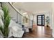 Chic foyer with curved staircase, modern railing, and hardwood flooring at 6039 E Laurel Ln, Scottsdale, AZ 85254