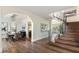 Open foyer showcases dining area, curved staircase, and gleaming hardwood floors at 6039 E Laurel Ln, Scottsdale, AZ 85254