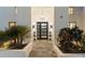 Welcoming front entryway with modern door, stylish lighting, and lush landscaping at 6039 E Laurel Ln, Scottsdale, AZ 85254