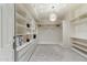 Spacious walk-in closet with custom shelving, drawers, hanging rods, and a stylish light fixture with marble floors at 6039 E Laurel Ln, Scottsdale, AZ 85254