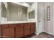 Double vanity bathroom with wood cabinets and large mirror at 6067 E Knolls S Way, Cave Creek, AZ 85331