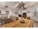 Bright dining area with wood table and chandelier, adjacent to living room at 6067 E Knolls S Way, Cave Creek, AZ 85331