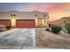 Two-car garage,desert landscaping, and sunset view at 6067 E Knolls S Way, Cave Creek, AZ 85331