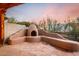 Charming stucco outdoor fireplace with seating area, perfect for cool evenings at 6067 E Knolls S Way, Cave Creek, AZ 85331