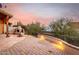 Landscaped patio with outdoor fireplace and seating area at 6067 E Knolls S Way, Cave Creek, AZ 85331