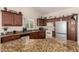 Open kitchen with granite counters and substantial cabinet space at 6331 S Cypress Point Dr, Chandler, AZ 85249