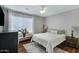 Bright bedroom featuring a comfortable bed and wood flooring at 7029 S 16Th Way, Phoenix, AZ 85042