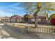 House exterior with a large tree and a brown fence at 7029 S 16Th Way, Phoenix, AZ 85042