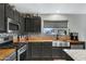 Kitchen with farmhouse sink, wood countertops, and stainless steel appliances at 7029 S 16Th Way, Phoenix, AZ 85042