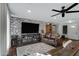 Living room featuring a leather couch and a brick wall at 7029 S 16Th Way, Phoenix, AZ 85042