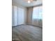 Bedroom with gray tile floors and double doors at 7150 W Montecito Ave, Phoenix, AZ 85033