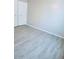 Simple bedroom with gray tile floors and double doors at 7150 W Montecito Ave, Phoenix, AZ 85033