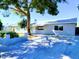 Single story home with landscaped yard and large tree at 7150 W Montecito Ave, Phoenix, AZ 85033