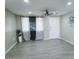 Living room with gray tile floors and large windows at 7150 W Montecito Ave, Phoenix, AZ 85033