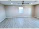 Bright living room features gray vinyl plank flooring and ceiling fan at 7150 W Montecito Ave, Phoenix, AZ 85033