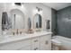 Modern bathroom with double sinks, arched mirrors, and updated fixtures at 7343 E Villa Way, Scottsdale, AZ 85257