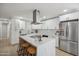 Modern kitchen features white cabinets, marble countertops, and stainless steel appliances at 7343 E Villa Way, Scottsdale, AZ 85257