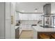 Modern kitchen with white cabinets, marble island, and gold accents at 7343 E Villa Way, Scottsdale, AZ 85257