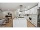 Modern kitchen with white cabinets and a large marble island at 7343 E Villa Way, Scottsdale, AZ 85257