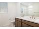 Double vanity bathroom with modern fixtures and wood cabinets at 7419 W Whitehorn Trl, Peoria, AZ 85383