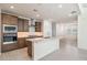 Modern kitchen with island, stainless steel appliances and dark wood cabinets at 7419 W Whitehorn Trl, Peoria, AZ 85383