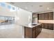 Modern kitchen with island, stainless steel appliances, and dark wood cabinets at 7419 W Whitehorn Trl, Peoria, AZ 85383