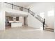 Two-story living room with modern staircase and kitchen view at 7419 W Whitehorn Trl, Peoria, AZ 85383