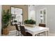 Bright dining room with white table, modern chairs, and large mirror at 7439 W Whitehorn Trl, Peoria, AZ 85383