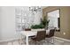 Elegant dining area showcasing a white table, brown leather chairs, and botanical art at 7439 W Whitehorn Trl, Peoria, AZ 85383