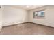 Simple bedroom with tile flooring and a large window at 7622 N 7Th Ave, Phoenix, AZ 85021