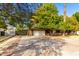 House exterior showcasing a spacious driveway and attached garage at 7622 N 7Th Ave, Phoenix, AZ 85021